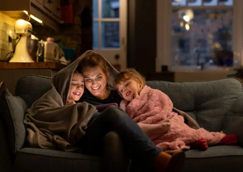 Family bundled up on the couch during winter in Dallas, TX 