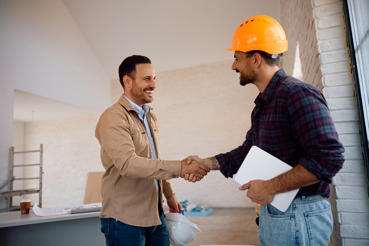 Homeowner shaking hands with foundation repair contractor in Dallas, TX
