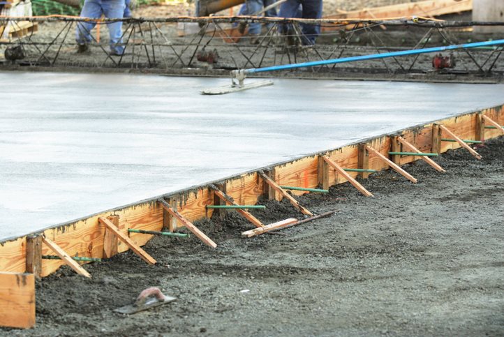 Freshly poured concrete slab with wooden formwork in Dallas, TX