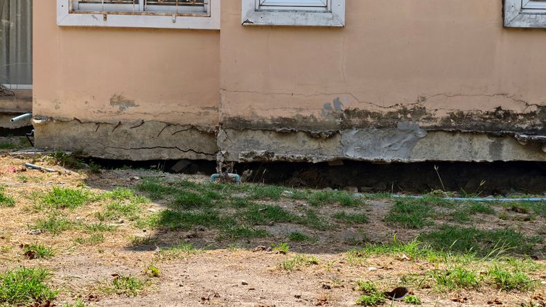 Cracked foundation and damage to a home's exterior wall in Dallas, TX